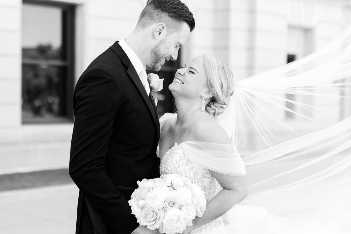 Wedding couple laughing outside