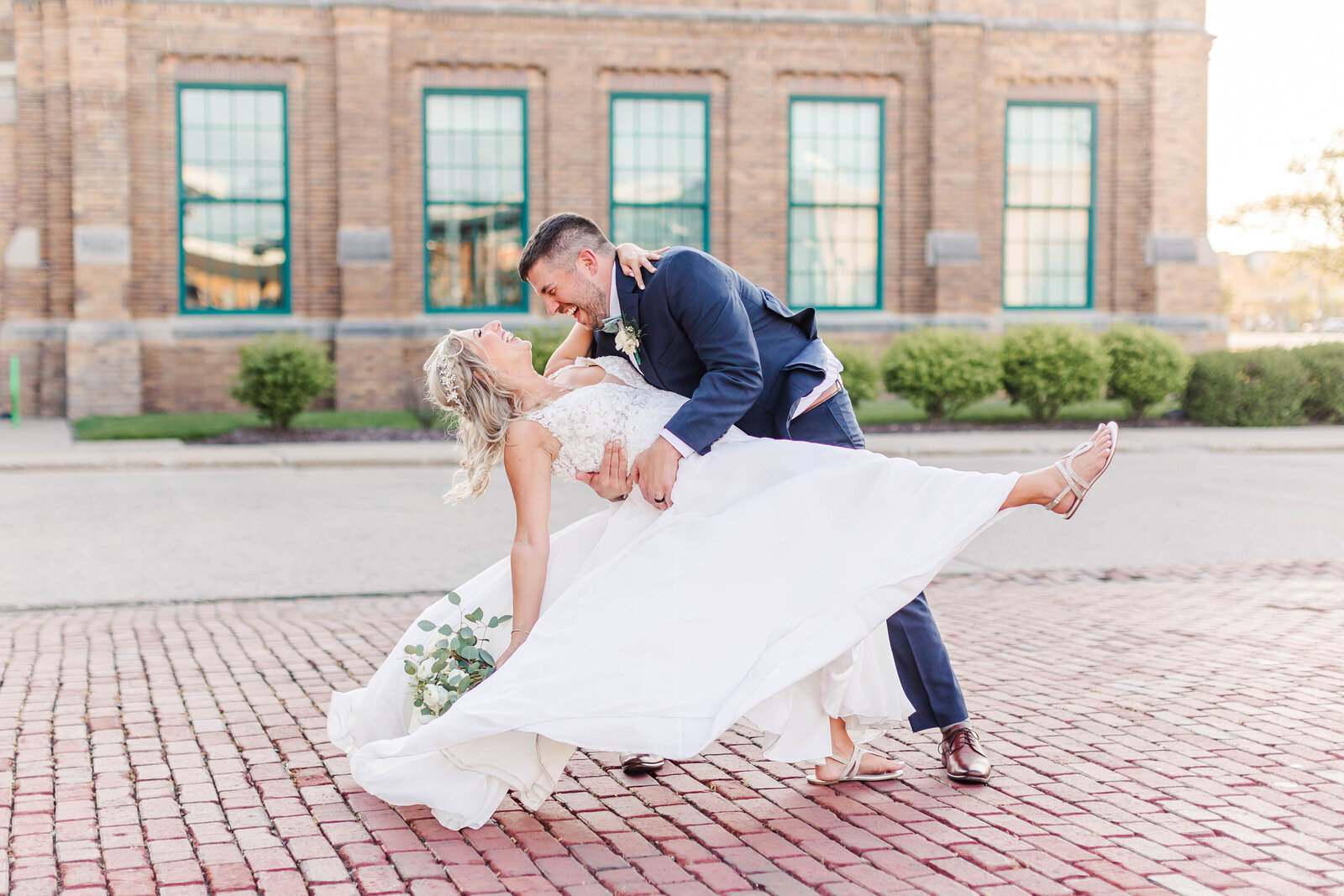 Wedding couple laughing outside
